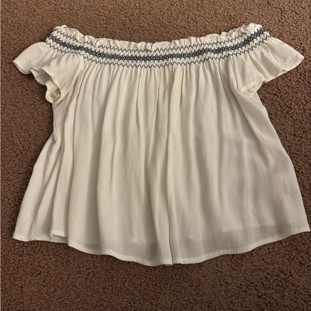 Garage white off the should tee size medium a little see through